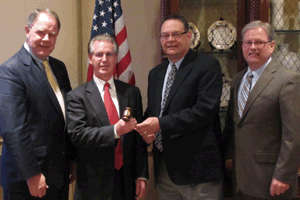 Passing the leadership gavel: (left to right) Chair-elect Alan Wessler, Incoming Chair Jeff Cannon, Al Gunderson and AFIA President Joel Newman